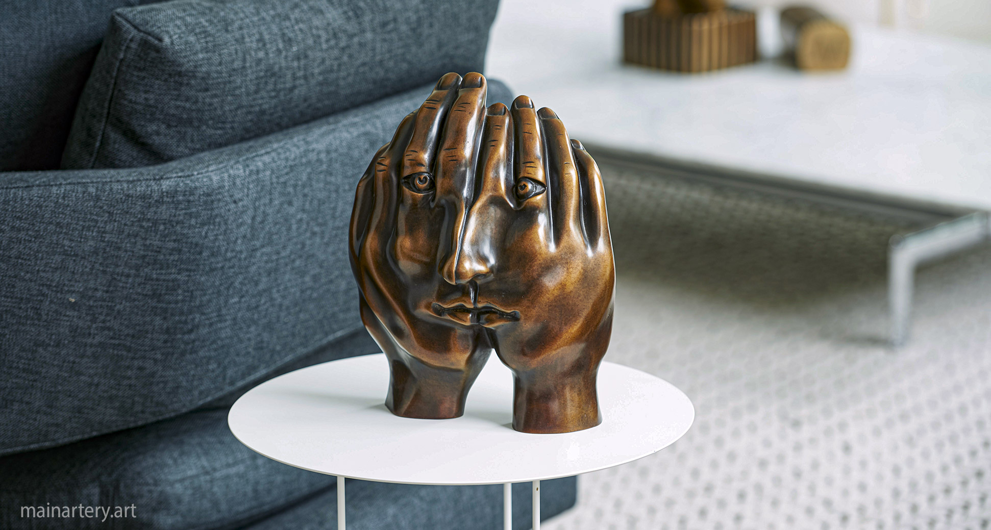 interior bronze representational face hands artwork image